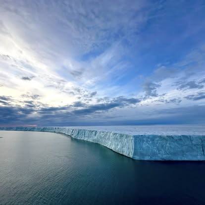 Arctic ice shelf meeting calm open water during SSI's Arctic expedition
